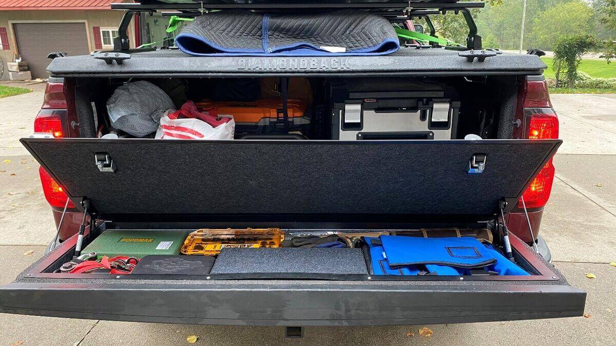 Pickup truck showing tailgate storage solutions with organized gear and tools.