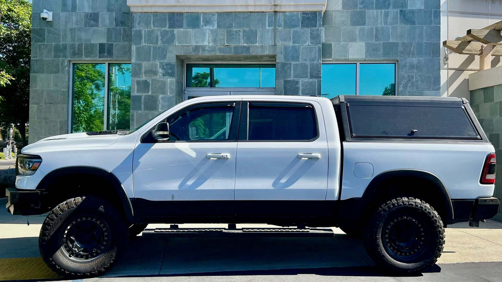 White ute with Aluminium Modular Canopies parked in front of modern building.