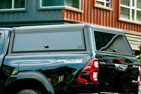 Black canopy for Ute on parked vehicle, showcasing durable design and sleek look.