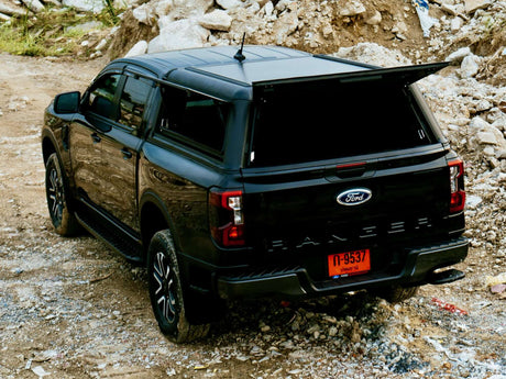 Black Ford Ranger NextGen Canopies on rugged terrain, showcasing utility and style in off-road settings.