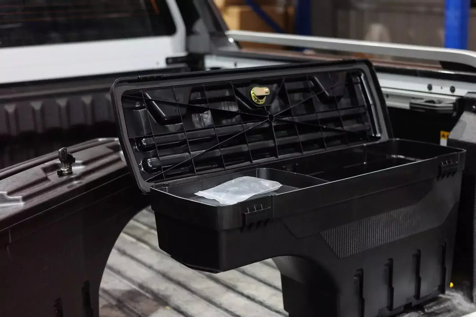 Tool Box for Utes: Empty black utility storage box in a ute tray, essential for tradesmen's organization and efficiency.