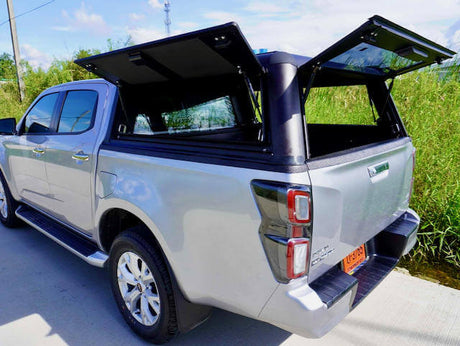Aluminium Ute Canopies in Australia shown on a parked ute with open canopy doors revealing storage space on a sunny day.