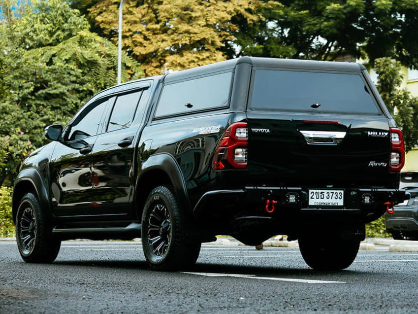 Black Toyota Hilux with canopy in urban setting showcasing Toyota Hilux Canopy design and functionality.