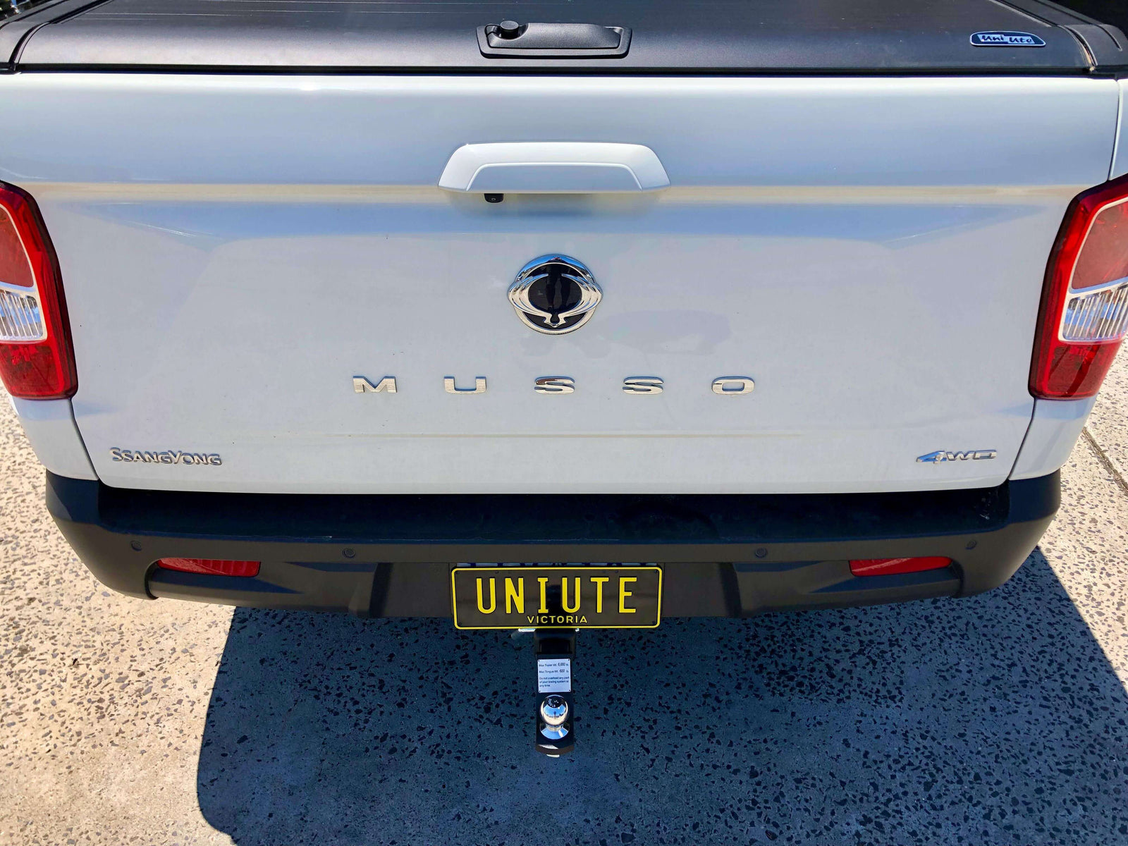 Custom Towbars attached to the rear of a white vehicle showcasing tailored solutions for every car model.
