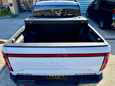 BYD Shark 6 hard lid tri-fold cover on 2025 model truck bed, showcasing style and security enhancements.