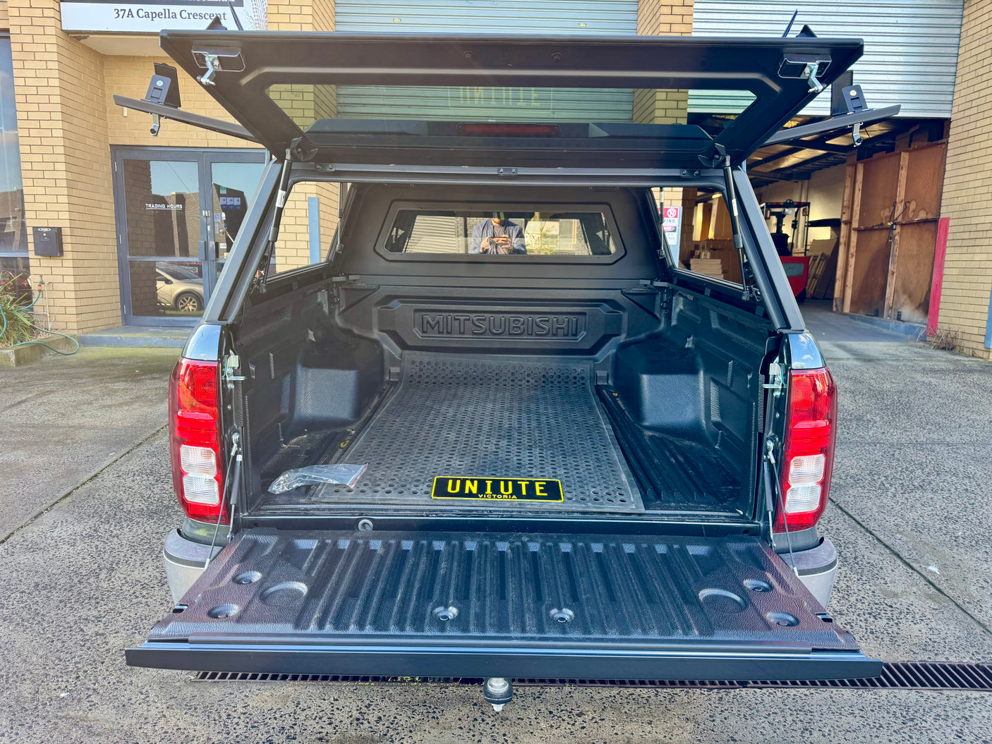 Mitsubishi Triton MV canopy — rear door open showing interior tub storage