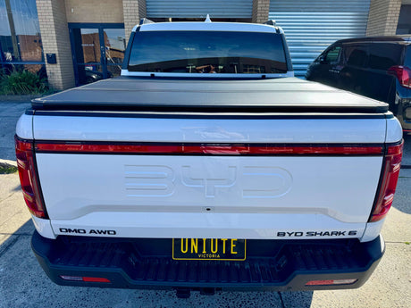 BYD Shark 6 hard lid cover on rear of 2025+ model ute, showcasing tri-fold design for secure storage and style enhancement.