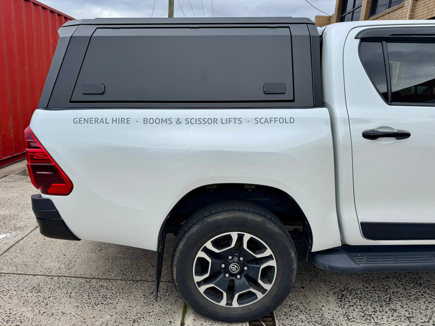 Hilux stainless steel canopy — side window open showing ventilation and access