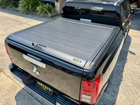 Nissan Navara D27 2026+ with UniUte manual roller shutter — side view closed