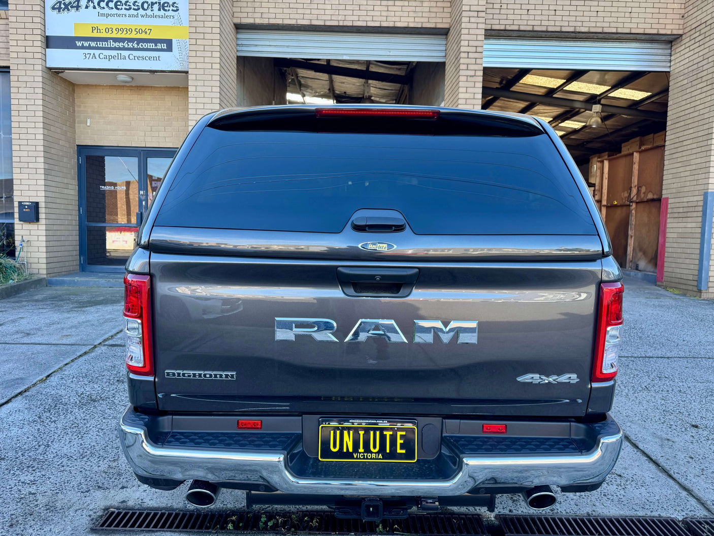 Rear view of RAM 1500 canopy for 2020-2025 model parked outside accessory store