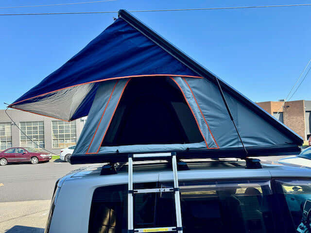 Aluminium hard shell roof top tent — awning extended providing shade