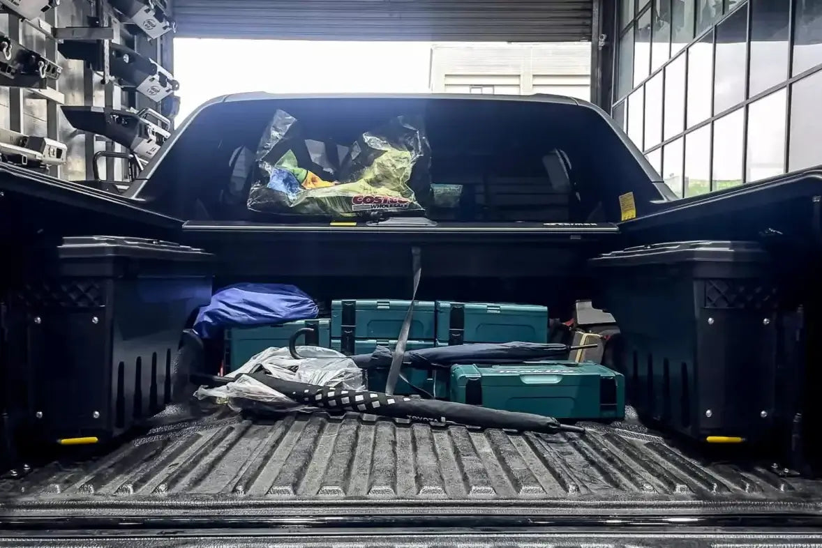 Toyota Hilux tool box with storage compartments, showcasing swing-out design for the 2015-2025 SR5 model in a garage setting.