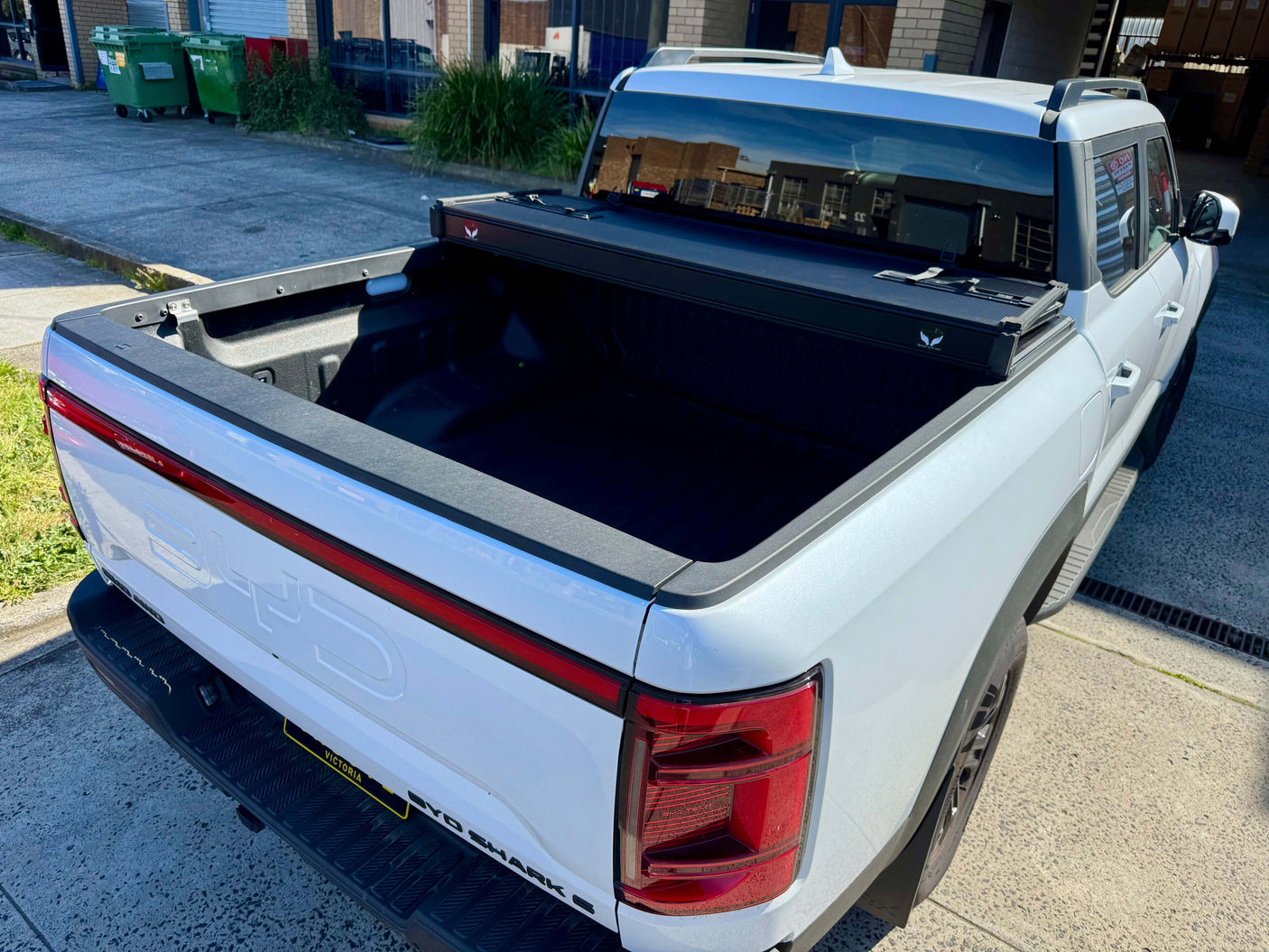 BYD Shark 6 hard lid tri-fold cover 2025+ model shown open on a truck bed