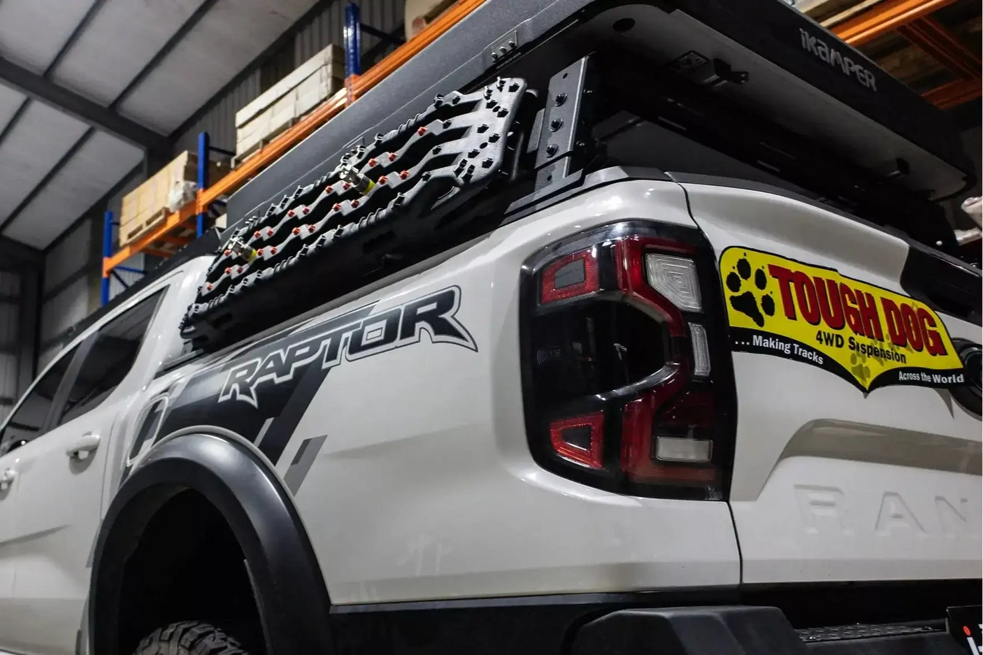 Truck with tub rack carrying gear, featuring the Universal Utility Multifunction Rack Carrier Cage for versatile hauling.