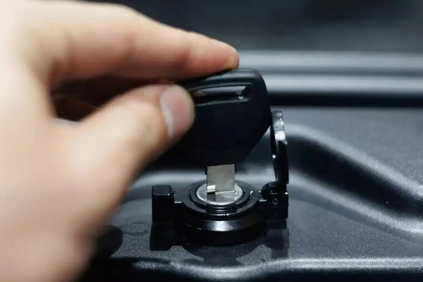 Person locking the KIA Tasman Tool Box with smart swing-out storage feature for 2025+ models.