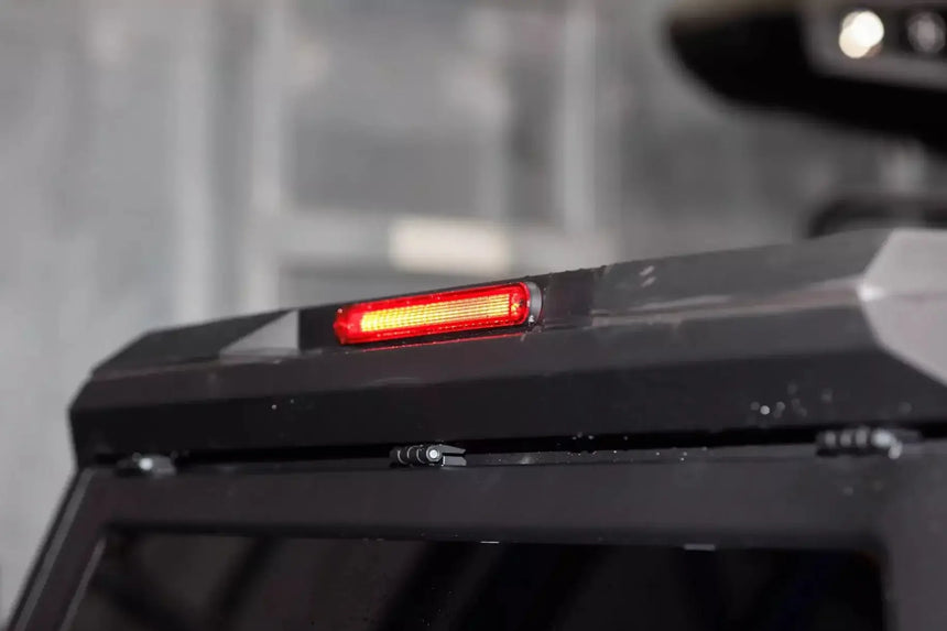 Close-up of stainless steel canopy Ford Ranger NextGen 2023+ with red brake light. High-quality ute accessory. Canopy ford ranger.