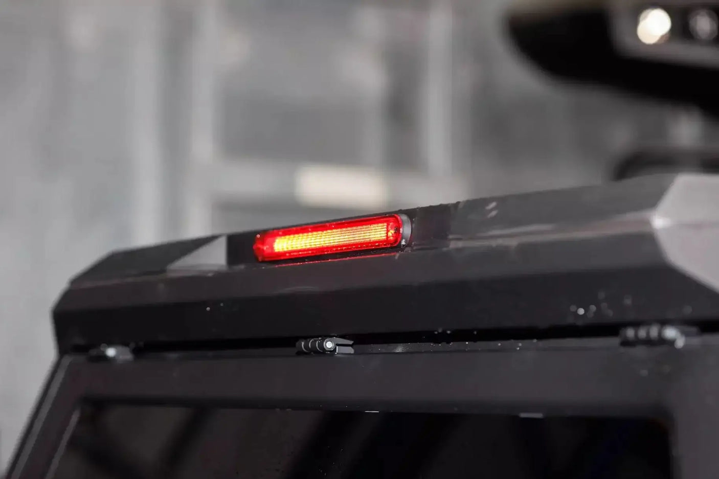 Close-up of stainless steel canopy Ford Ranger NextGen 2023+ with red brake light. High-quality ute accessory. Canopy ford ranger.