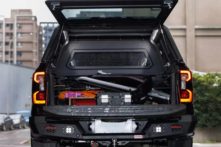 Stainless steel canopy ford ranger NextGen 2023+ with open tailgate showcasing storage capacity and durability in urban setting.