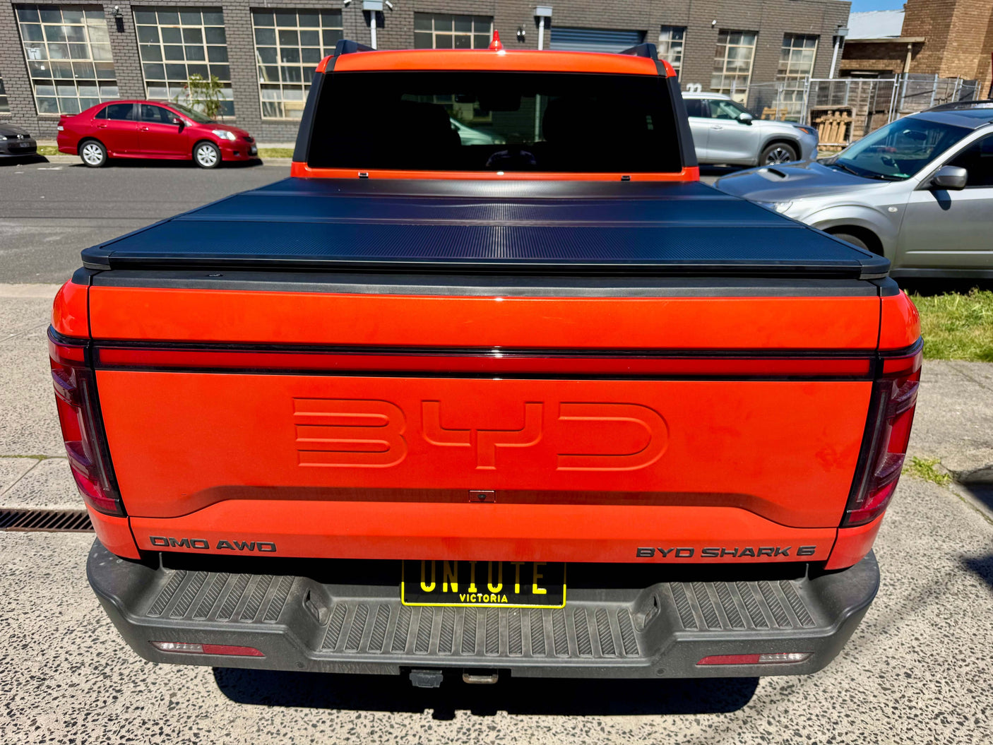 BYD pickup truck featuring a BYD Shark 6 hard lid tri-fold cover, showcasing its fit and utility for 2025+ models.