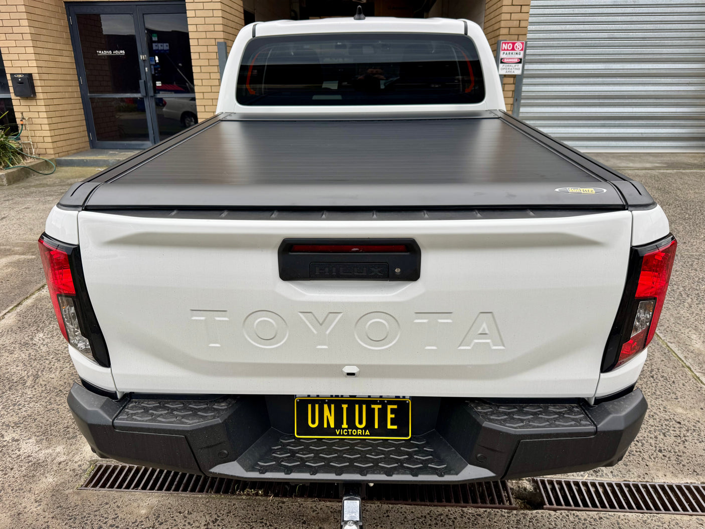 Electric roller shutter on Toyota Hilux N80 N90 — side profile showing low-profile aluminium slats