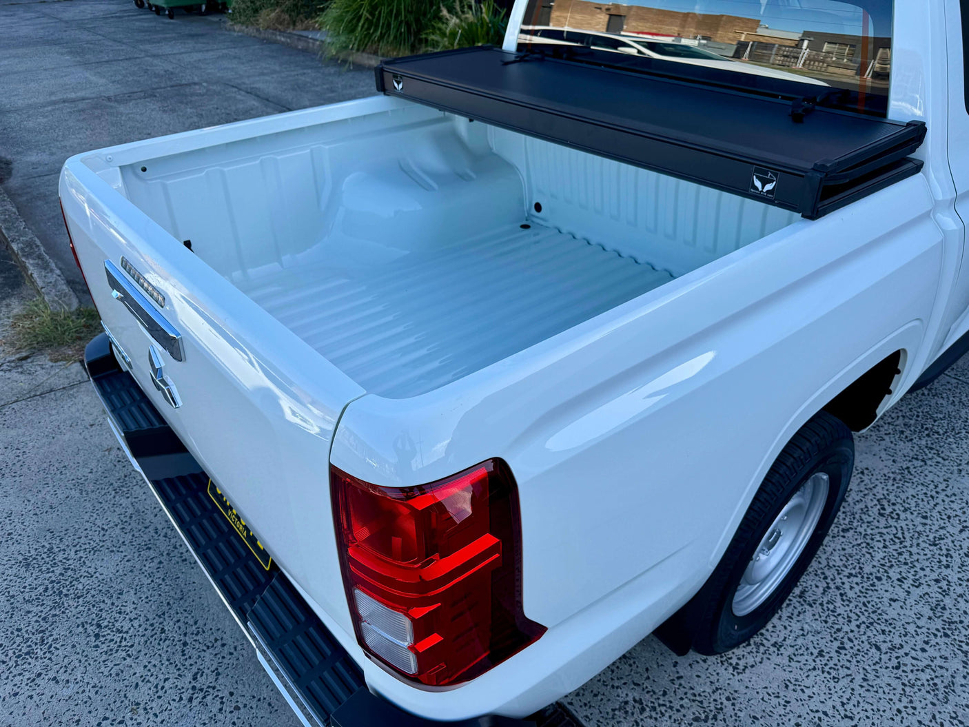 Tonneau cover Mitsubishi Triton MV 2024+ tri-fold hard lid showcasing durable truck bed protection.