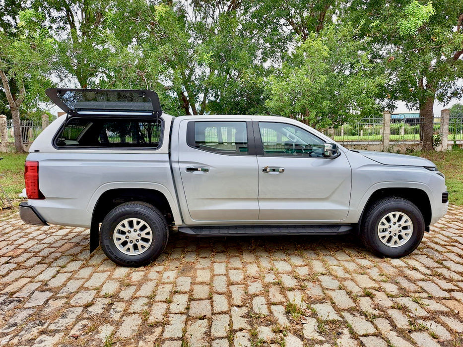 Side view of a Mitsubishi Triton MV 2024 with FORCE PRO triton canopy in a natural setting.