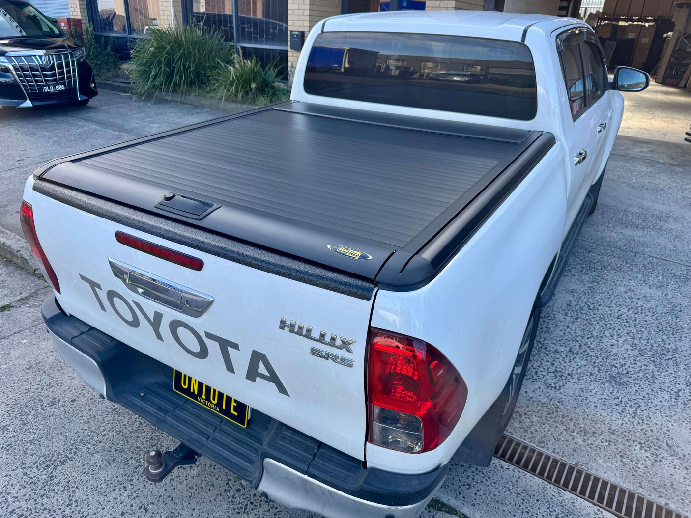 Back view of a white Toyota Hilux SR5 with a UniUte Gen2 toyota hilux roller shutter for ultimate ute protection and style.