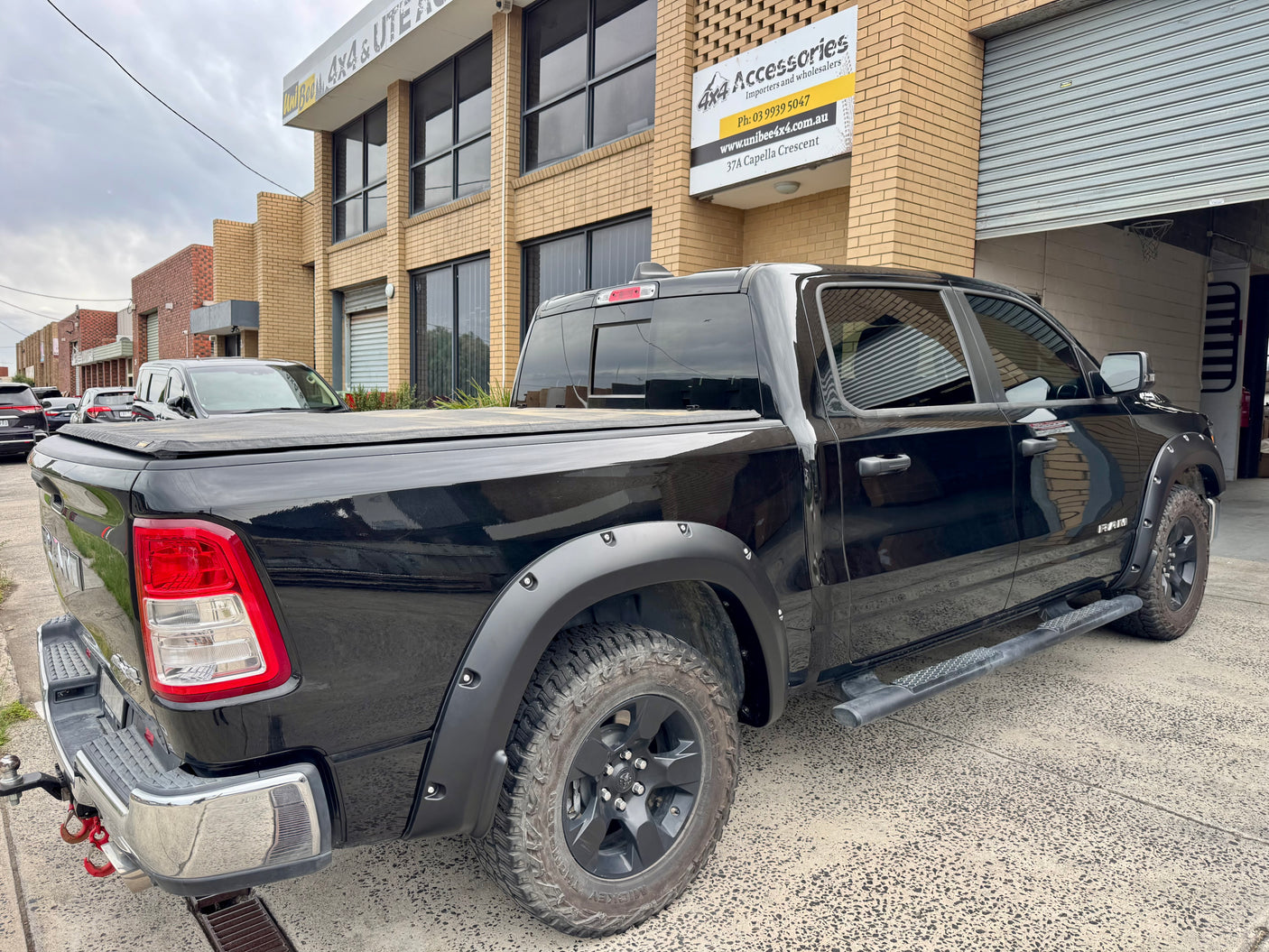 RAM 1500 DT with textured fender flares — rear view showing arch coverage