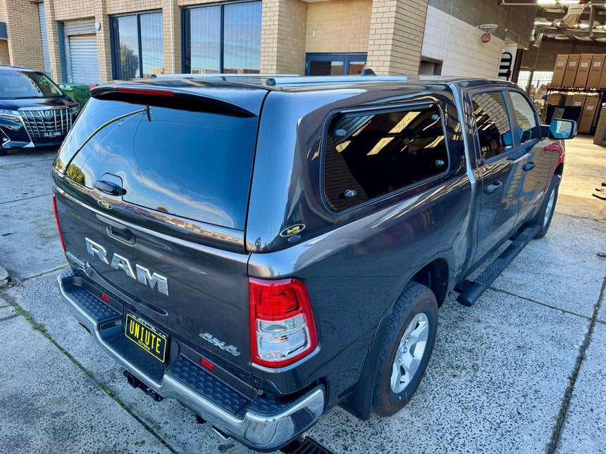 Grey RAM 1500 canopy installed, designed for RAM 1500 DT 2020–2025, showing rear view.