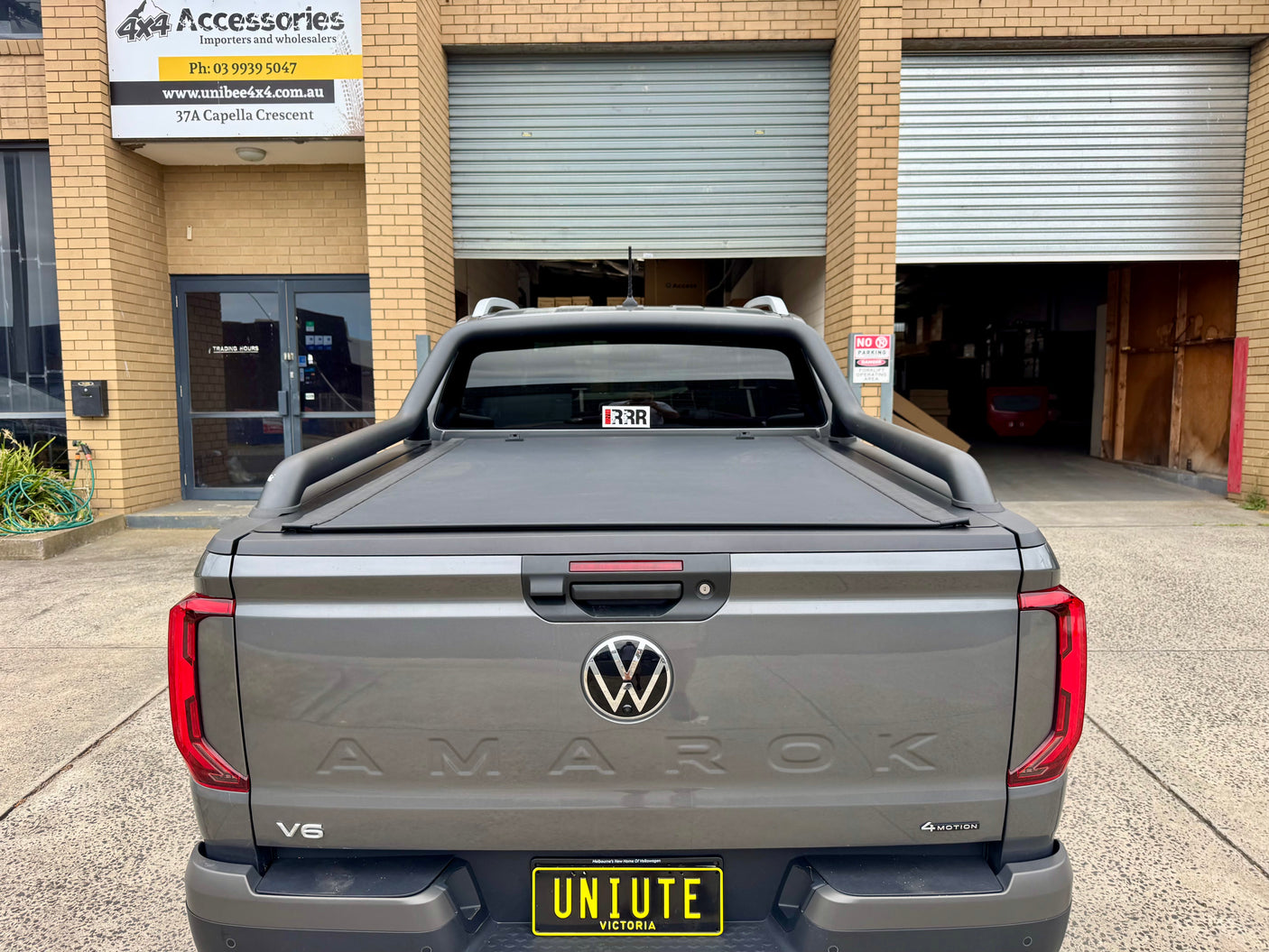 REVOLVER tonneau on Volkswagen Amarok 2023+ — partially rolled showing tub access