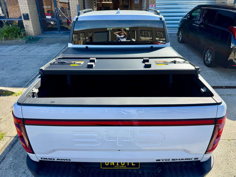 BYD Shark 6 hard lid tri-fold cover for 2025+ models installed on ute for style and security.