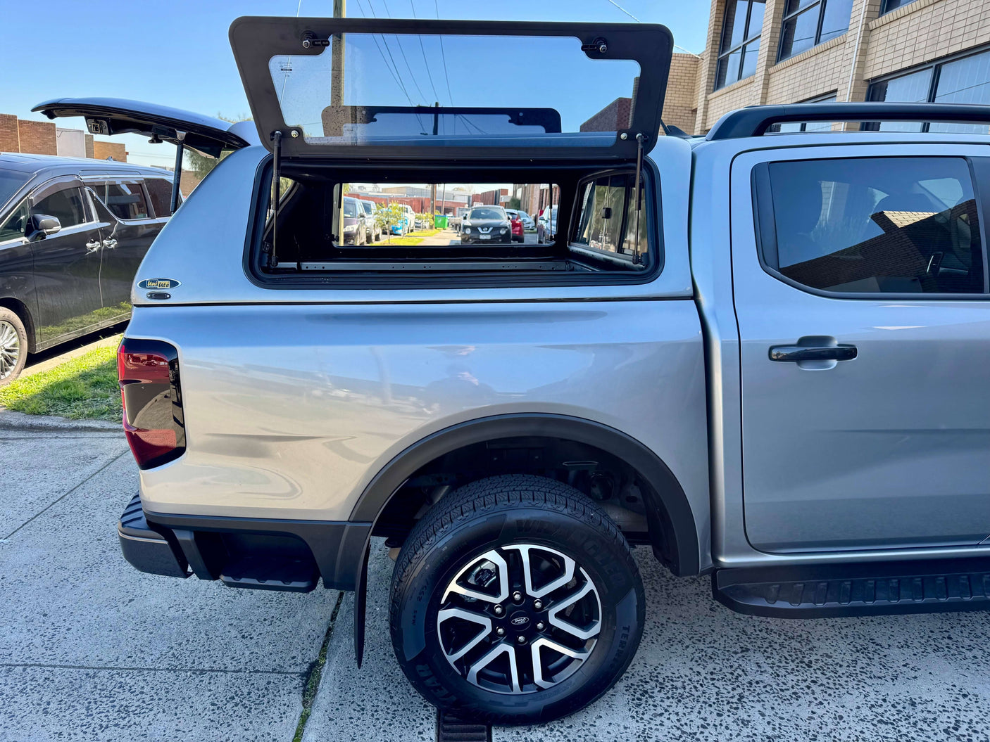 ford ranger canopy on silver NextGen RA 2022-2025 vehicle parked outdoors
