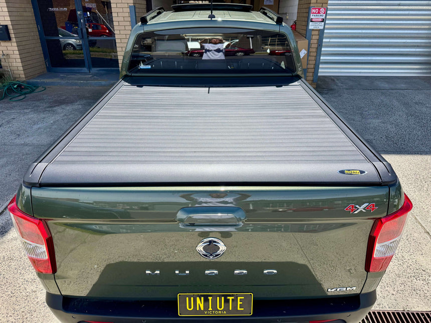 Rear view of SsangYong Musso Ute with roller shutter installed, showcasing the electric musso ute roller shutter for 2018-2025 long tub model.