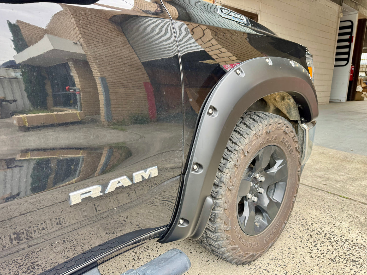 RAM 1500 DT with fender flares — rear wheel arch close-up showing fit