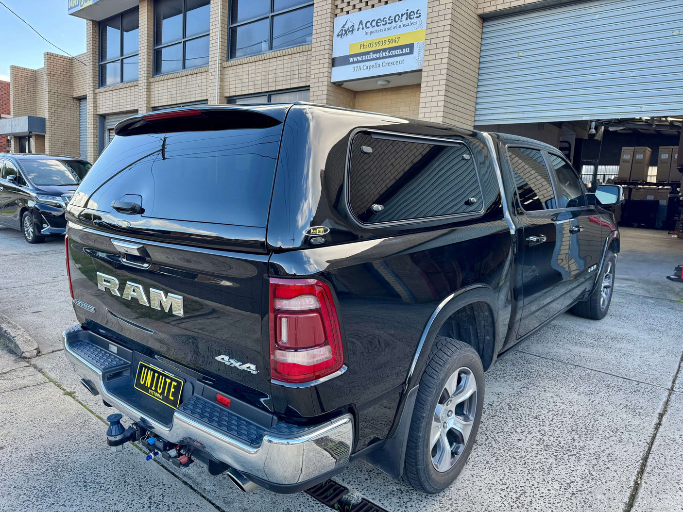 RAM 1500 Canopy FORCE PRO on RAM 1500 DT 2020-2025, parked outside a workshop