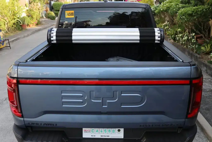 BYD SHARK 6 with HR REVOLVER Hard Rolling Cover for 2025+ showcasing the byd shark 6 tray cover in an urban setting