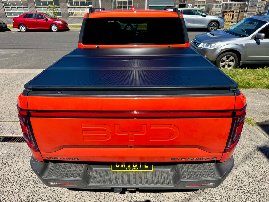 BYD Shark 6 Hard Lid 2025+ Tri-Fold Hard Tonneau Cover on Red Truck