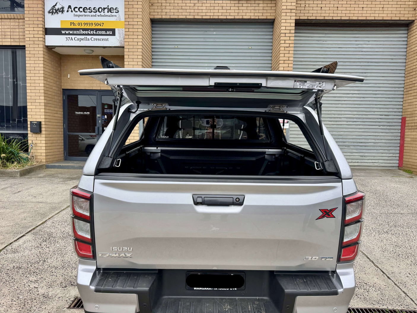 Rear view of an Isuzu D-Max with FORCE PRO canopy DMax 2020-2025 by UniUte, showcasing open canopy and rugged design.
