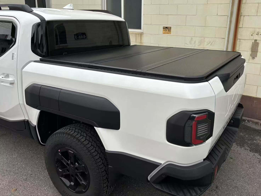 KIA Tasman Hard Lid 2025+ Tri-Fold Hard Lid Cover providing superior cargo protection and style for your ute.