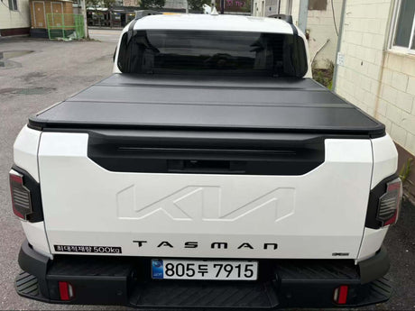 Rear view of a KIA Tasman hard lid cover, showcasing cargo protection and sleek design.