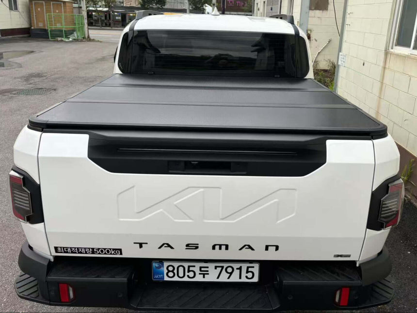 Rear view of a KIA Tasman hard lid cover, showcasing cargo protection and sleek design.