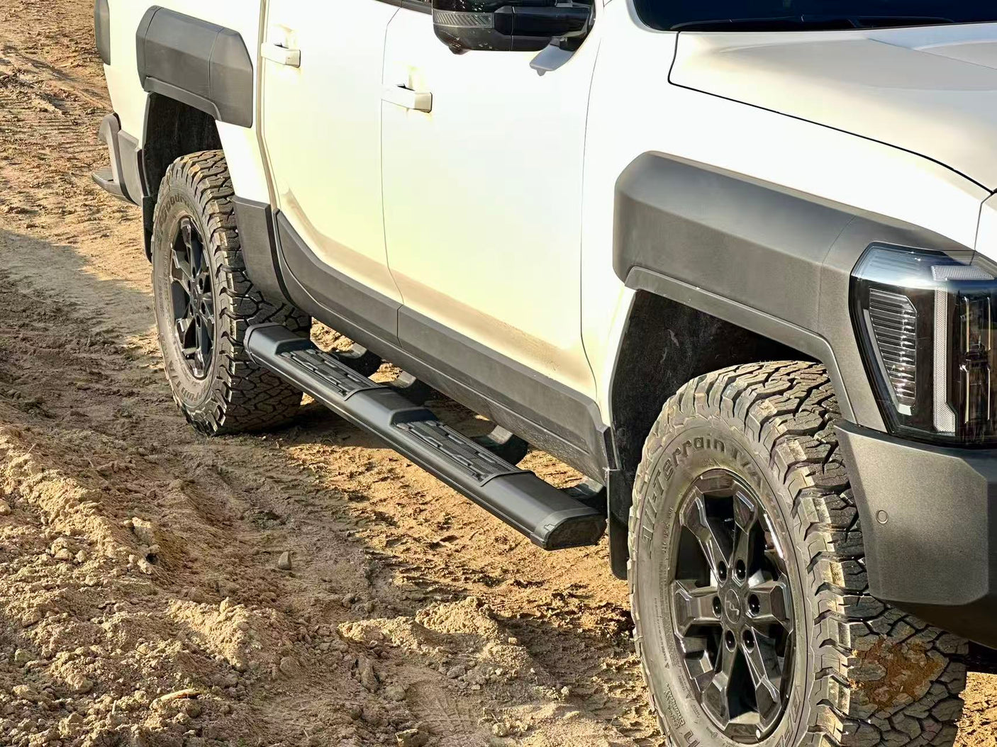 KIA Tasman side steps 2025+ black side bars on rugged off-road vehicle showcasing durable design and enhanced protection