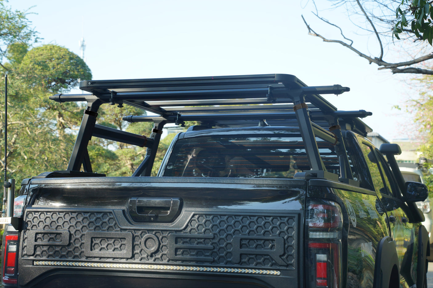 Heavy Duty Aluminium Ladder Rack installed on a black ute with adjustable roller covers.