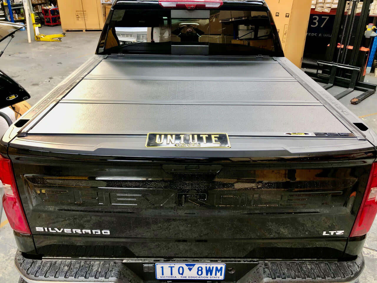 Silverado 1500 quad-fold lid — front panel open showing tub access