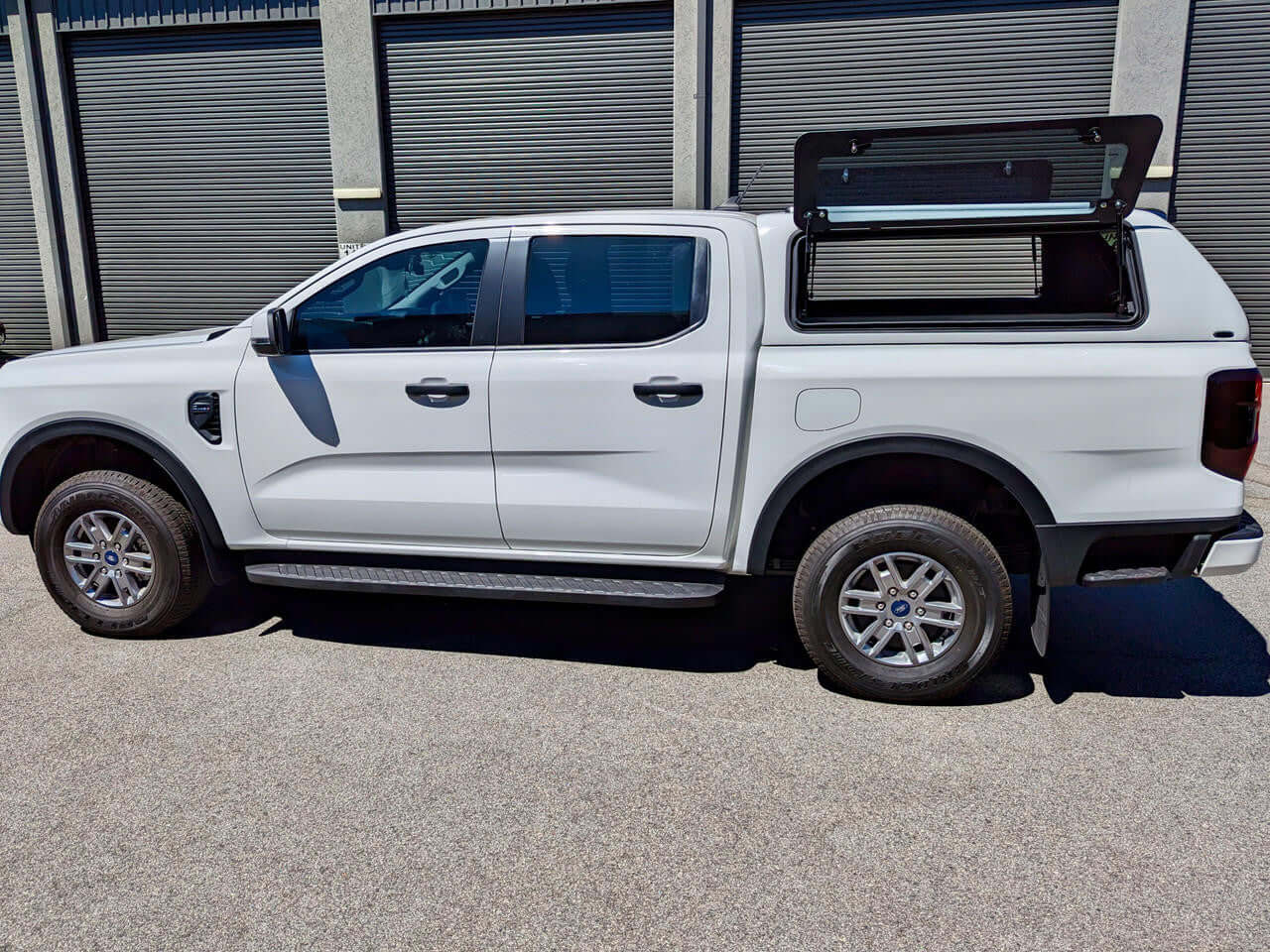 Ford Ranger Canopy FORCE PRO for RA NextGen 2022-2025 in white, showcased on a parked vehicle, ideal for work and adventure.