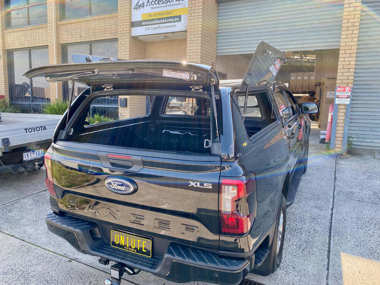 Ford Ranger canopy showcasing open rear view at a garage, enhancing versatility and style, 2022-2025 model.