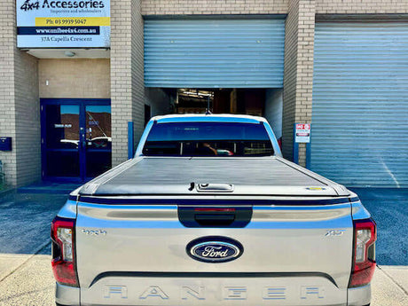 Next Gen Ford Ranger with UniUte ranger roller shutter at a 4x4 accessories shop.