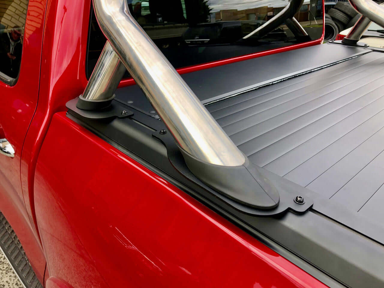Close-up of a GWM Cannon Roller Cover 2020-2025 EGen2 Electric Roller Shutter installed on a red truck bed, showcasing sleek design.