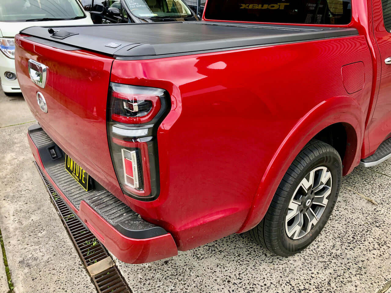 Red GWM Cannon truck featuring UniUte EGen2 Electric Black Roller Shutter for 2020-2025 with gwm cannon roller cover.