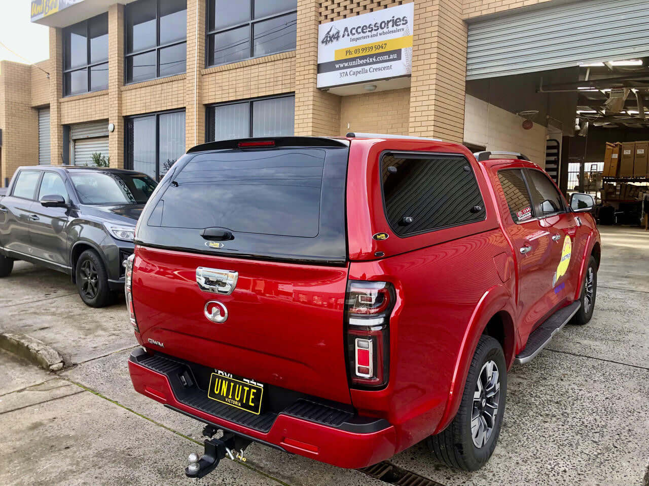 Red GWM Cannon canopy parked outside building style and functionality.